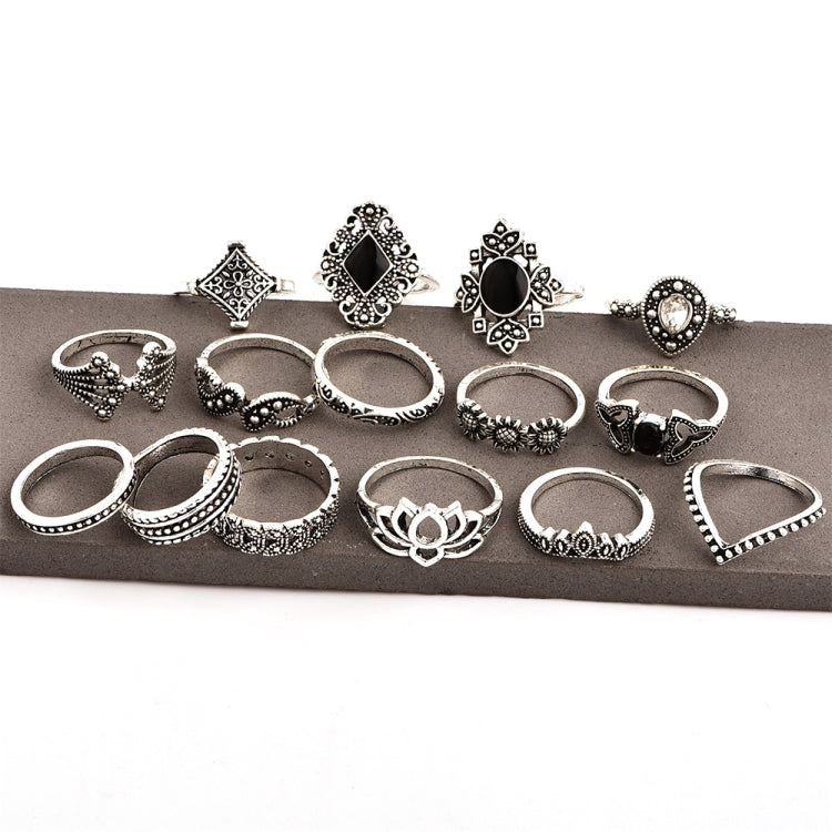 Row of silver-tone ornate rings with black and clear accents, boho geometric designs