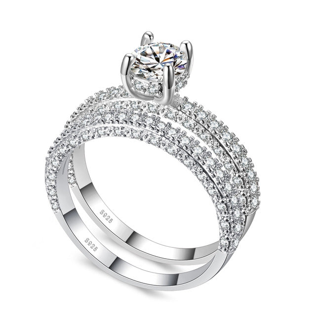 Double-row cubic zirconia ring set in silver tone with round center stone
