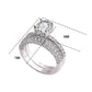 Double-row cubic zirconia wedding ring with round center stone in white gold tone
