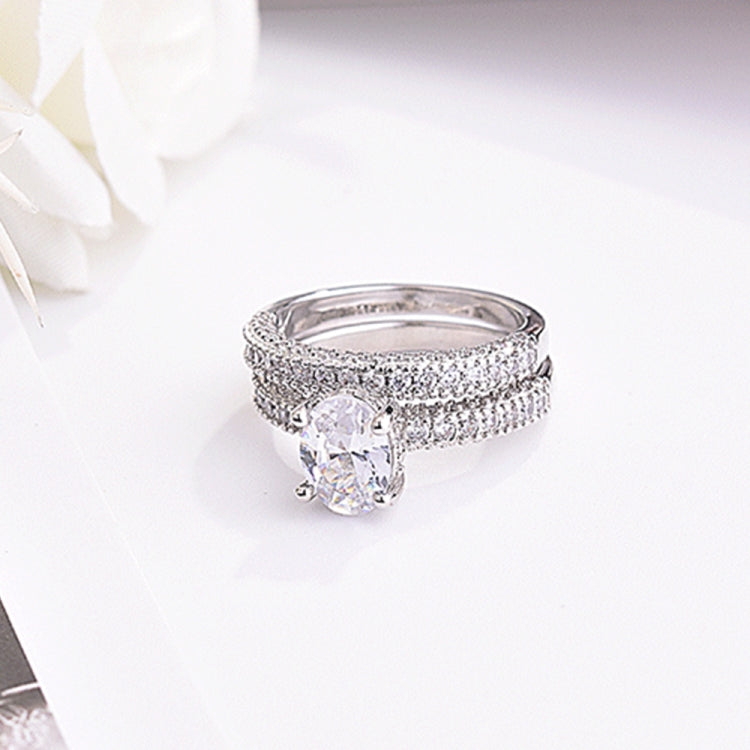 Cubic zirconia engagement ring with oval center stone and double-row band