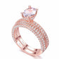 Rose gold double-row cubic zirconia wedding ring with large round center stone, halo style