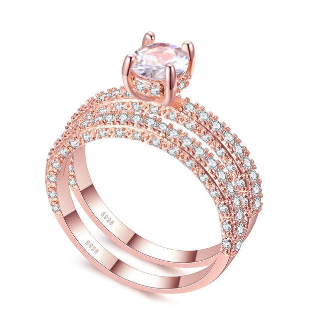 Rose gold cubic zirconia engagement ring with round center stone and double halo bands