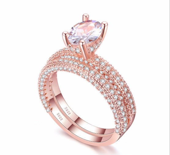 Rose gold double-row cubic zirconia engagement ring with oval center stone