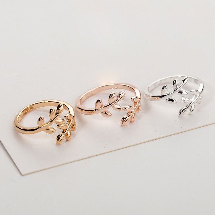 Open leaf-branch adjustable rings in rose gold and silver, three-ring display