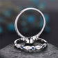Silver-tone stacked rings with scalloped settings and small blue accent stones