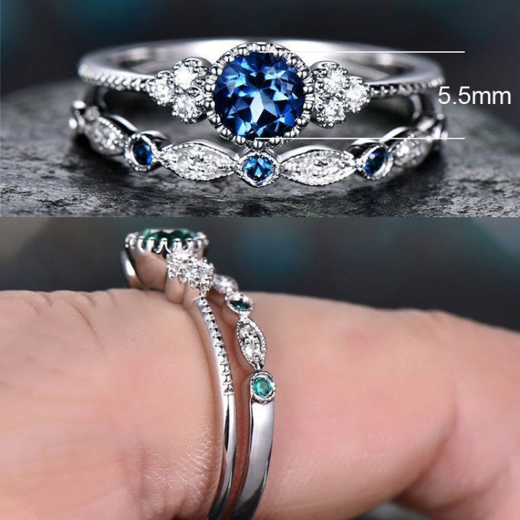 Silver-tone two-ring set with large round blue gemstone and small blue side stones