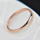 Polished rose gold stainless steel ring with smooth rounded band