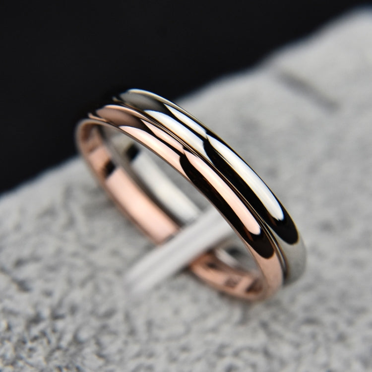 Stacked two-tone rings with rose gold and black polished metal bands