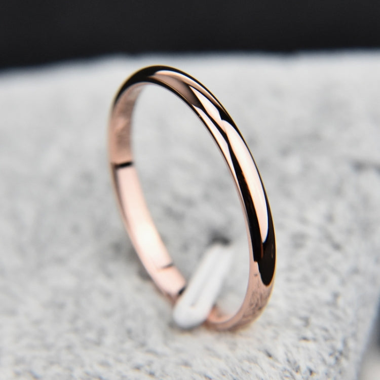 Two-tone stainless steel ring with rose gold outer edge and black inner stripe