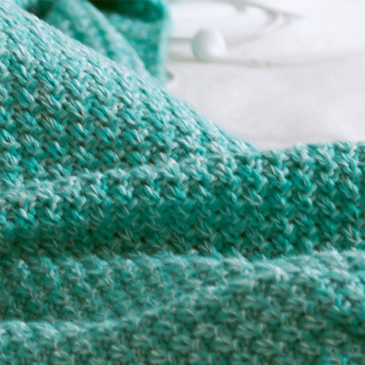 Knitted mermaid tail blanket in teal, close-up of textured fabric weave