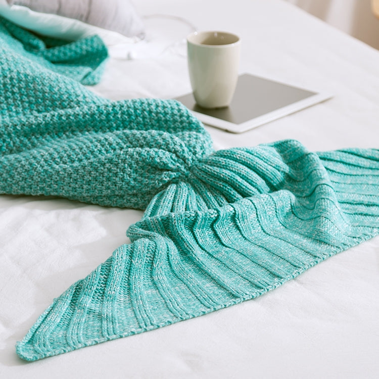 Knitted mermaid tail blanket in teal, folded fin and gathered tail knot