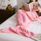 Mermaid tail blanket in pink knit with ruffled fin end