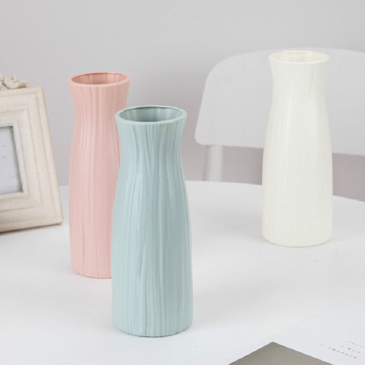 Set of ribbed plastic vases in pink, blue, and milk white, tall desktop flower holders
