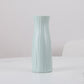 Light blue ribbed plastic vase, tall desktop flower holder