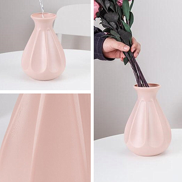 Pink plastic fluted teardrop vase with faux flower bouquet