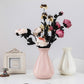 Pink plastic vase centerpiece with faux flower bouquet and matching white vase