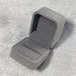 Flannel grey jewelry gift box, open interior with padded insert on textured fabric