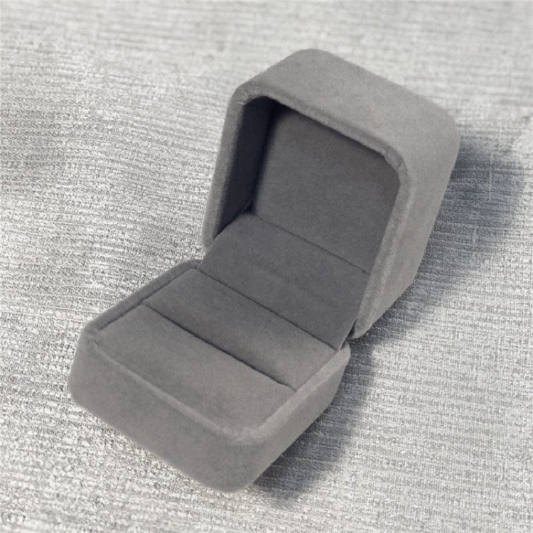 Flannel grey jewelry gift box, open interior with padded insert on textured fabric