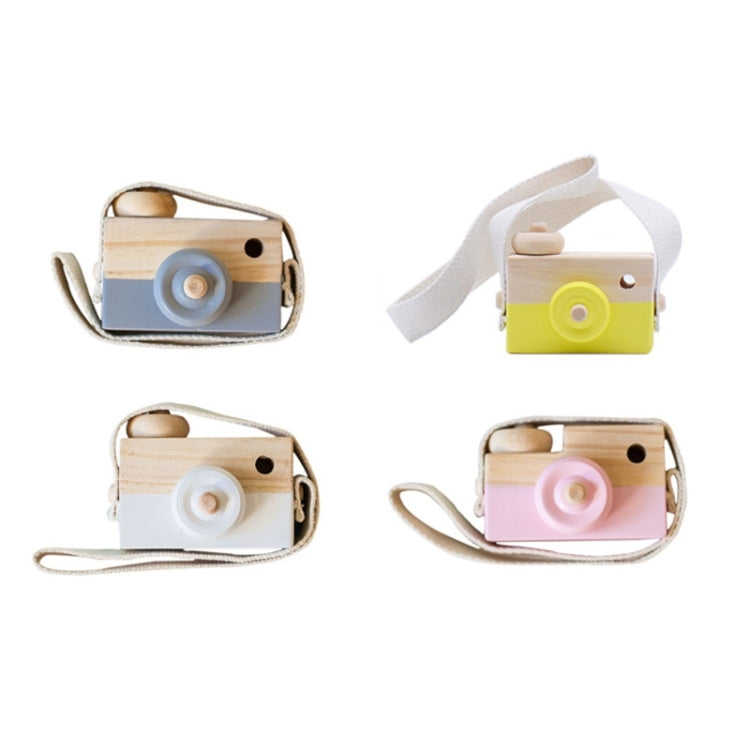 Assorted wooden camera toys with round lenses and fabric straps in yellow, pink, white, and blue