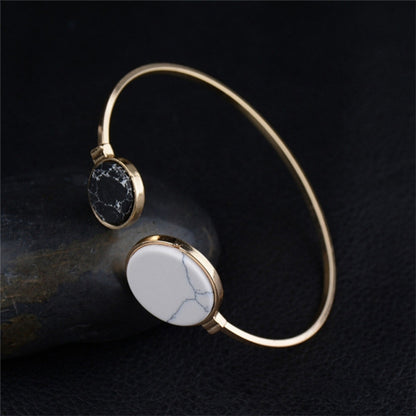 Gold-tone round geometric bangle bracelet with black marble and white marble discs