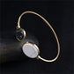 Gold-tone circular cuff bangle set with black and white faux stone round inlays