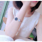 Gold-tone marble round cuff bangle bracelets on model's arm, black and white discs