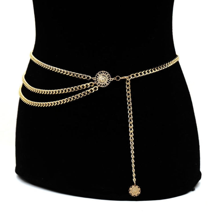 Gold high-waist chain belt with ornate circular clasp and long dangling chain