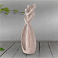 Sandstone cameo statue with heart-shaped top, textured beige stone love figure.