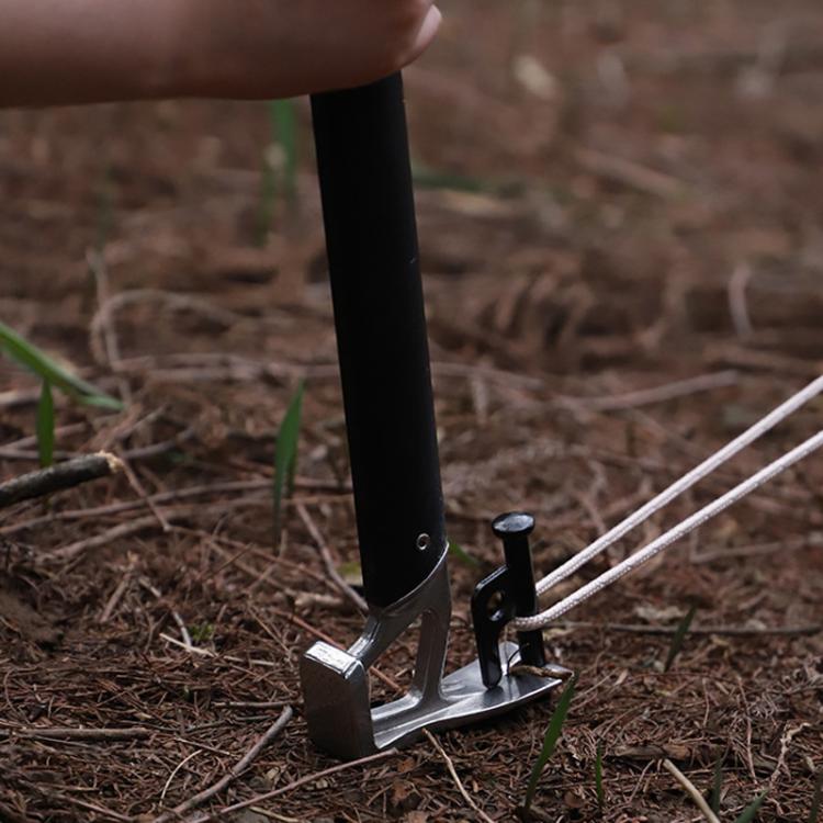 Black tent stake mallet in use with claw head and stake puller on ground