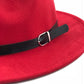 Red felt fedora hat close-up showing black band and metal buckle