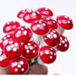 Handheld mini foam mushrooms: glossy red caps with white spots and white stems