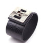 Wide black leather cuff bracelet with silver-tone square logo plate and metal clasp
