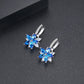 Blue and clear flower-shaped cubic zirconia stud earrings with silver-tone huggers
