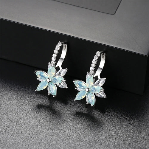 Light blue flower-shaped cubic zirconia stud earrings with silver-tone prong backs