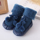 Blue baby winter floor socks with pom-pom ties and soft fuzzy cuffs
