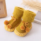 Winter baby bootie socks with pom-poms, fleece lining, yellow knit