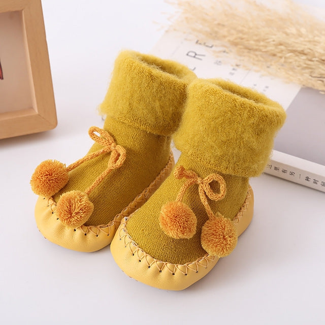 Winter baby bootie socks with pom-poms, fleece lining, yellow knit