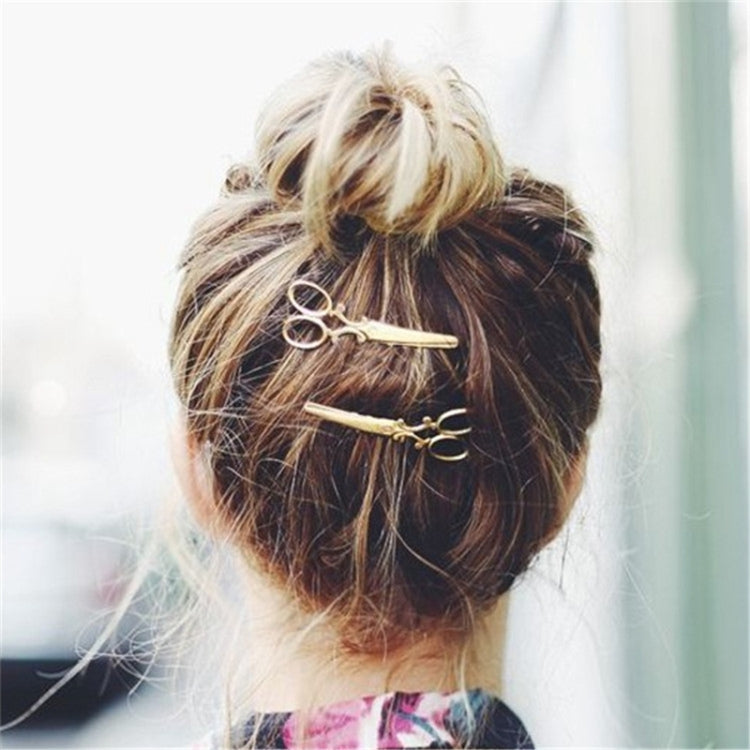 Silver hair clips (2-pack) with swirl bar accents, pinned to blonde hair bun
