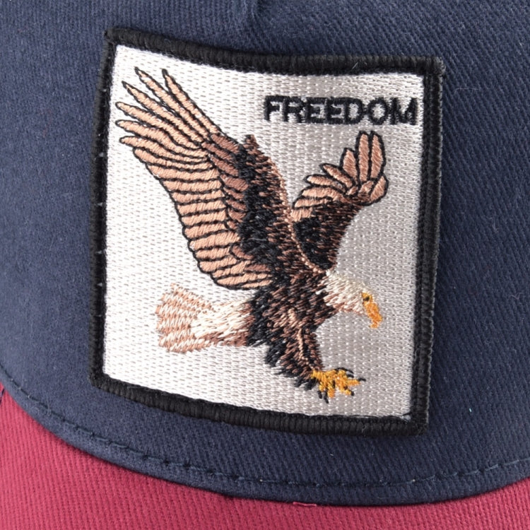 Embroidered animal patch on navy baseball cap with “FREEDOM” text and eagle design.