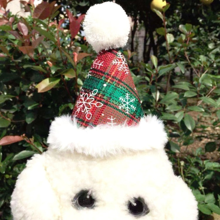 White dog plush wearing Christmas plaid hat with pom and bow tie