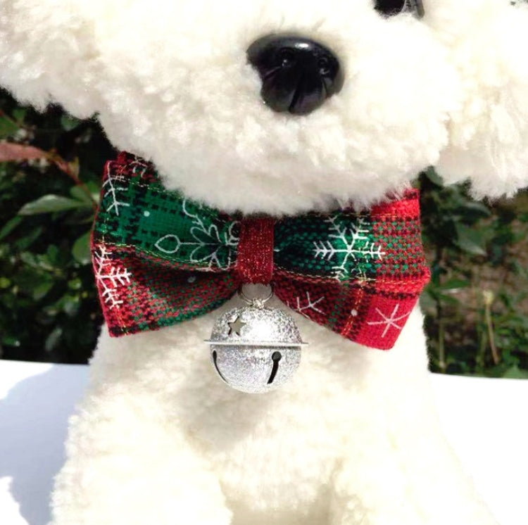 Dog plush close-up: plaid bow tie with silver bell charm