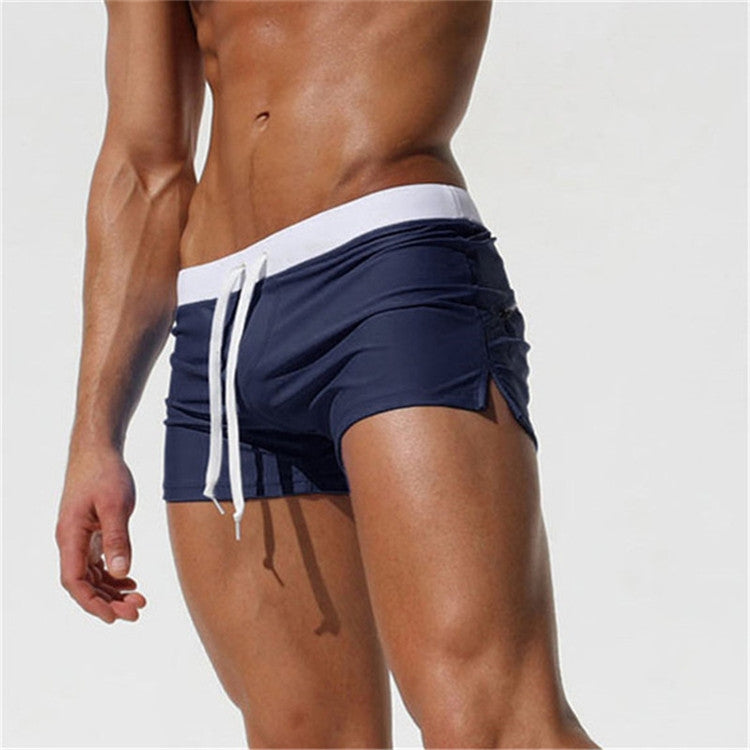 Men's navy swim shorts with white trim, drawstring waist, and side pockets