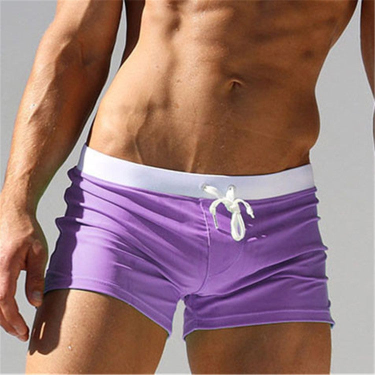 Men's purple swim shorts with white waistband trim and white drawstring