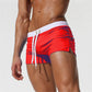 Men's red swim shorts with white trim and drawstring waist, side pockets
