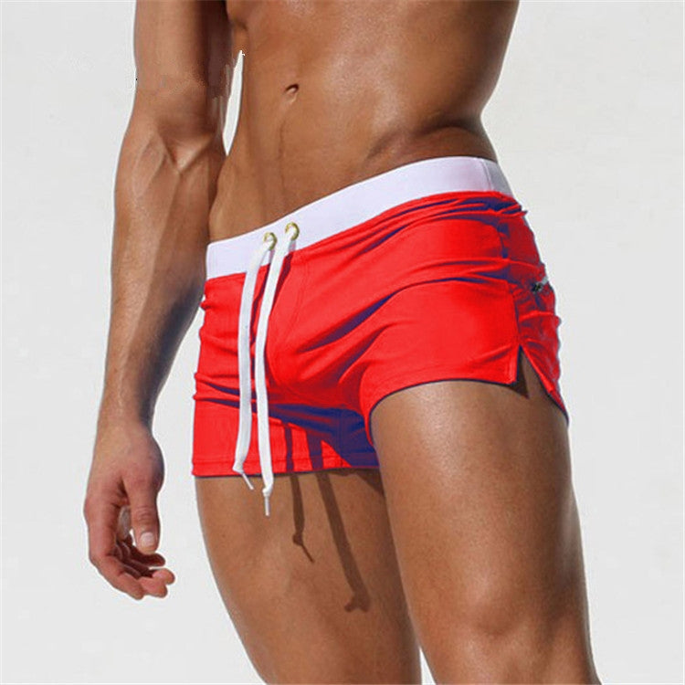 Men's red swim shorts with white trim and drawstring waist, side pockets