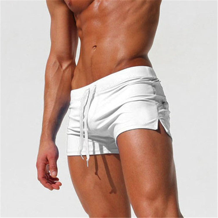 Men's white swim shorts, side view, with drawstring waist and pockets
