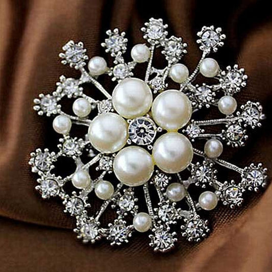 Gold-tone snowflake brooch pin with pearl-like beads and clear rhinestone accents