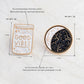 Two enamel brooch pins: “Good Vibes” bottle and gold-rimmed moon constellation pin.