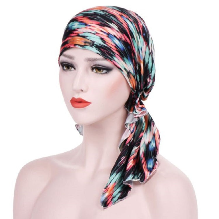 Stretch printed turban hat with long side tail, colorful black and blue geometric stripe pattern