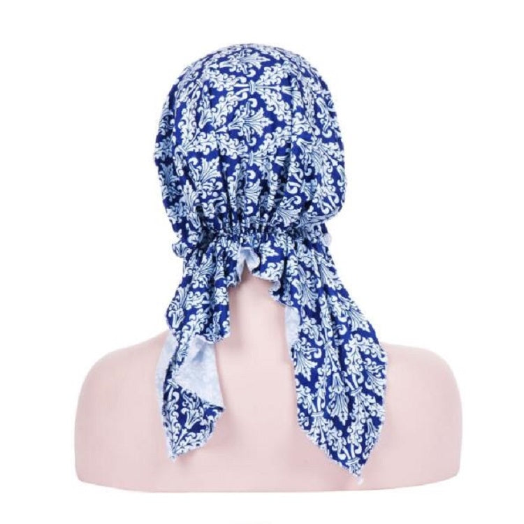 Stretch printed turban hat with long back tail, blue and white damask pattern